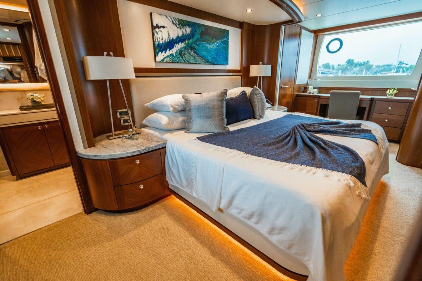 a bedroom with a bed and a desk aboard NEW ARRIVAL Yacht for Sale
