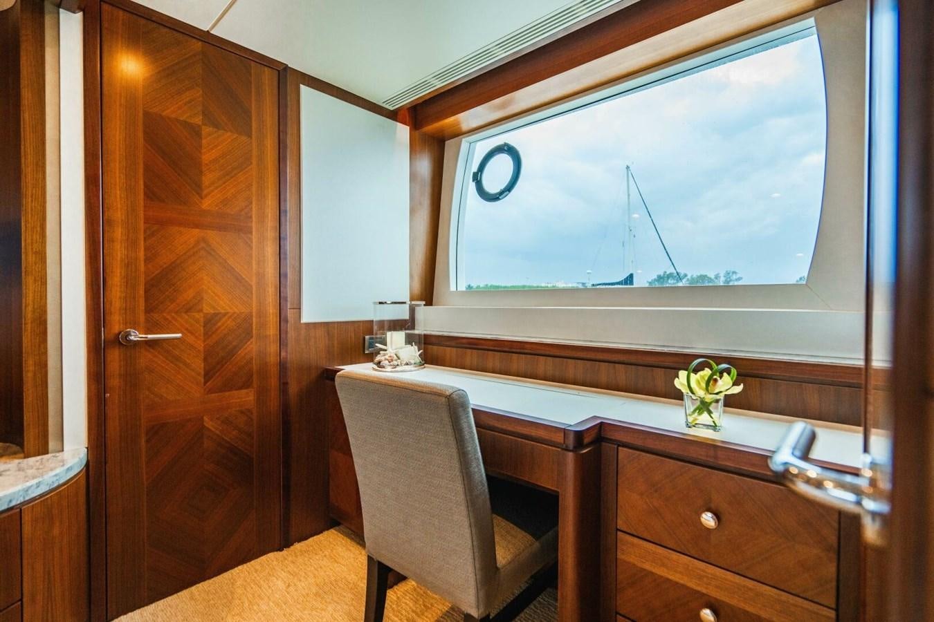 a room with a chair and a window aboard NEW ARRIVAL Yacht for Sale