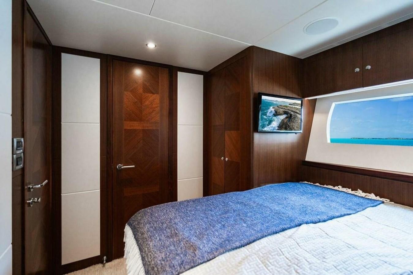 a bedroom with a bed and a television aboard NEW ARRIVAL Yacht for Sale