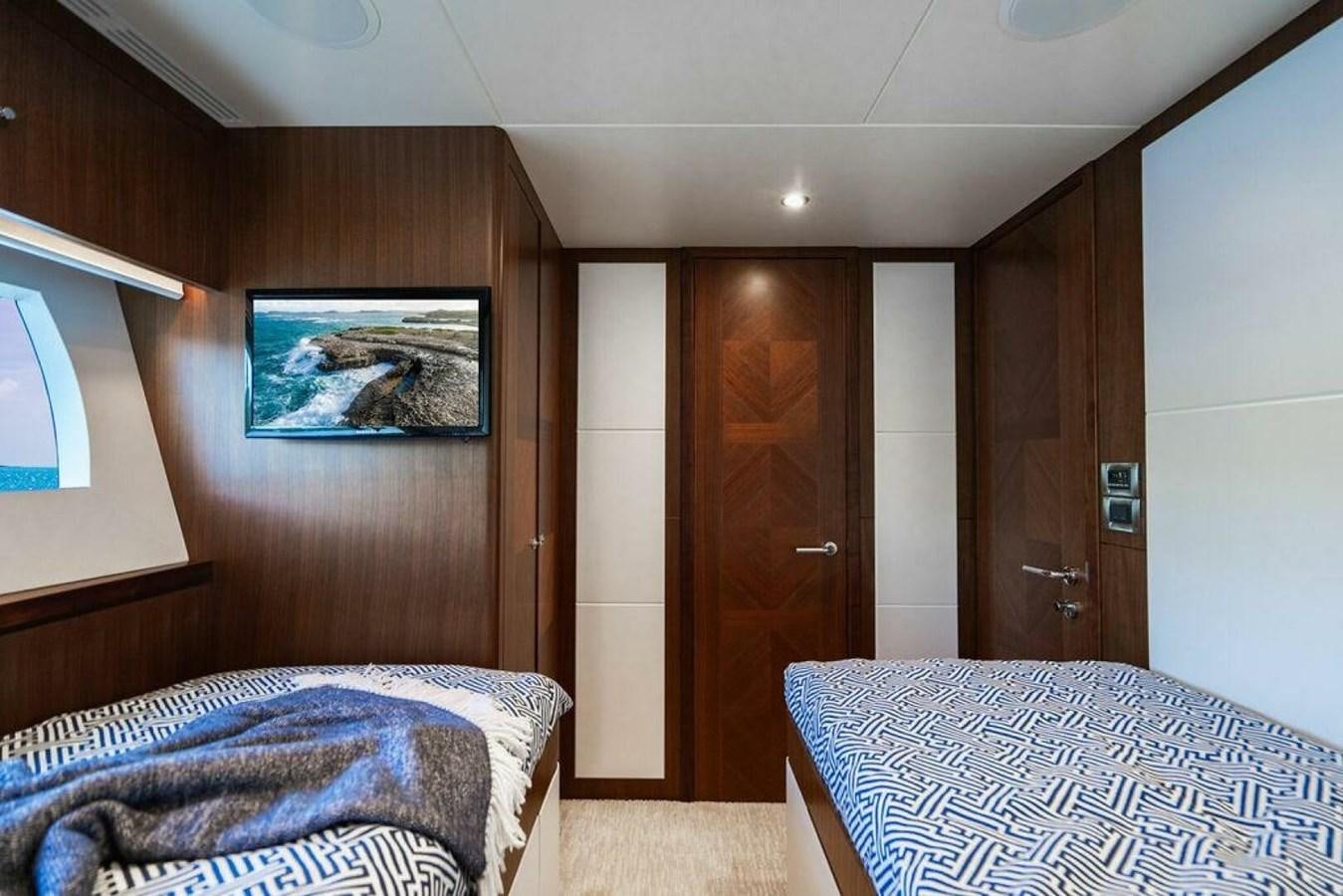 a bedroom with a bed and a television aboard NEW ARRIVAL Yacht for Sale