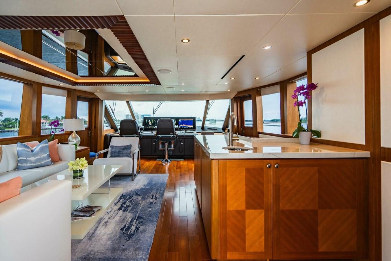 a room with a wood floor and white couches aboard NEW ARRIVAL Yacht for Sale