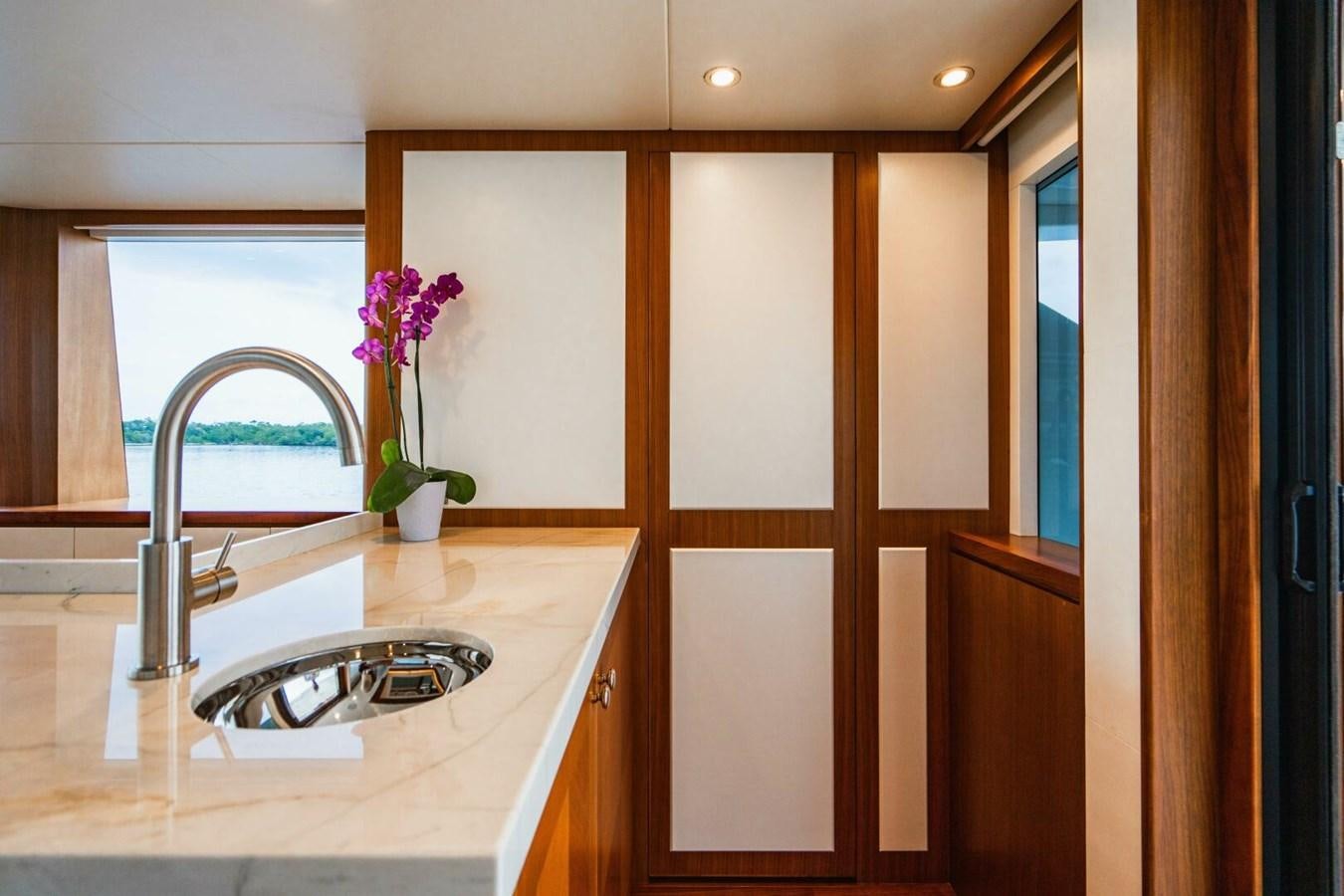 a kitchen with a sink and cabinets aboard NEW ARRIVAL Yacht for Sale