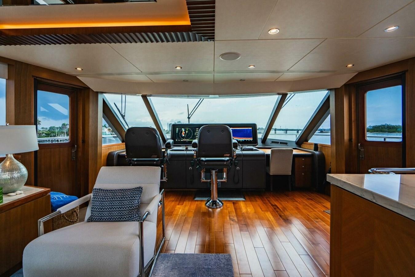 a room with a table and chairs aboard NEW ARRIVAL Yacht for Sale
