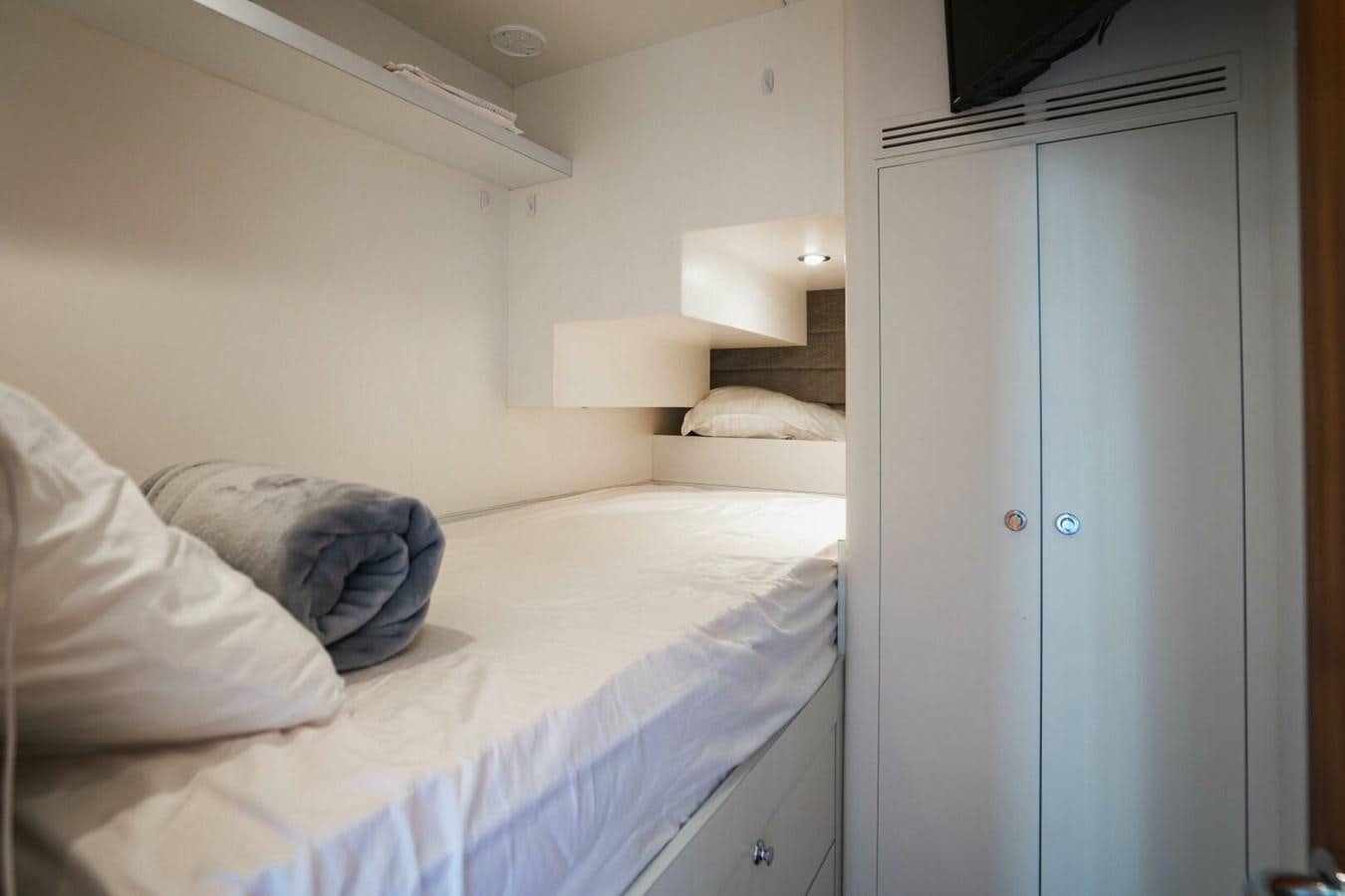 a room with a bed and a closet aboard NEW ARRIVAL Yacht for Sale