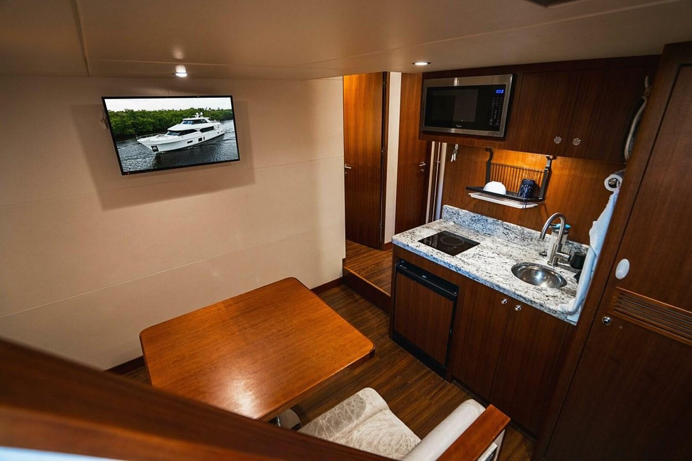 a kitchen with a table and tv aboard NEW ARRIVAL Yacht for Sale