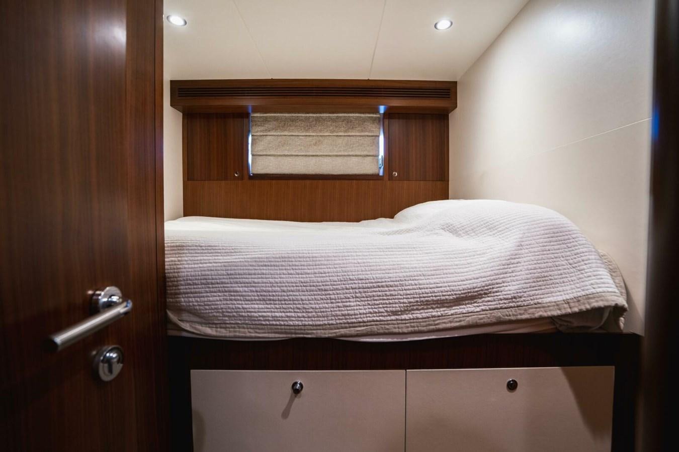 a bed with a wooden headboard aboard NEW ARRIVAL Yacht for Sale