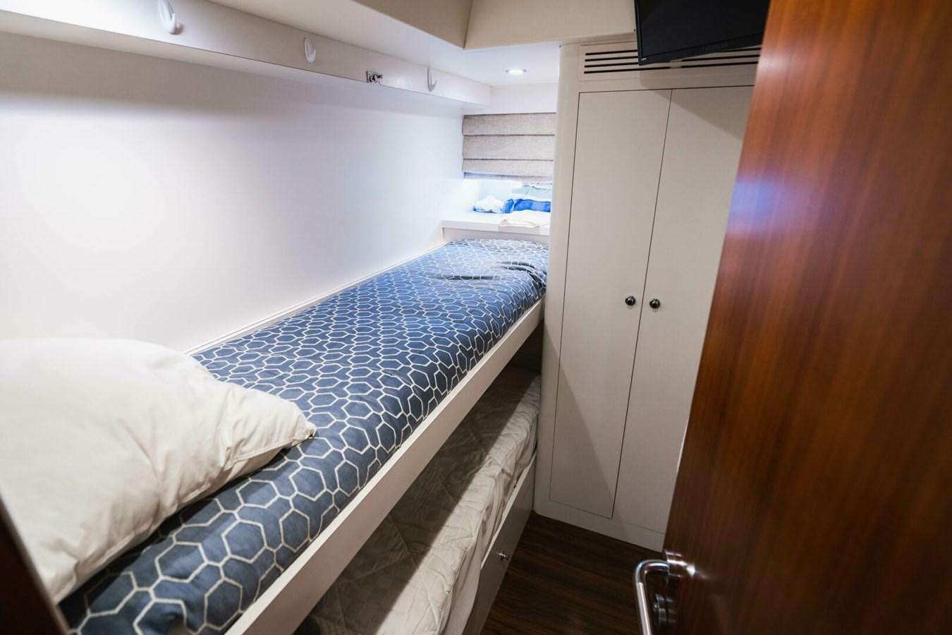 a room with a bed and a closet aboard NEW ARRIVAL Yacht for Sale