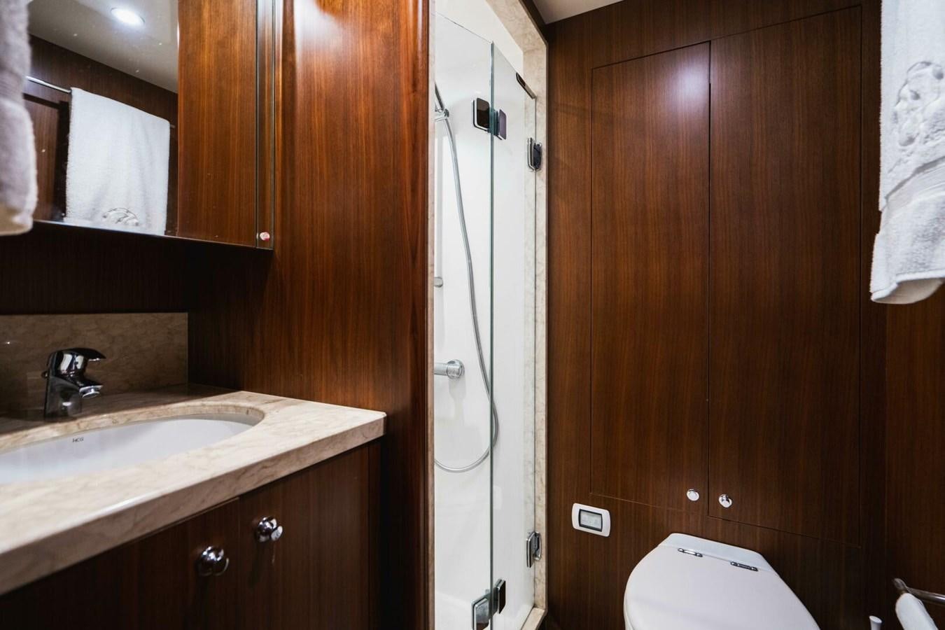 a bathroom with wooden cabinets aboard NEW ARRIVAL Yacht for Sale