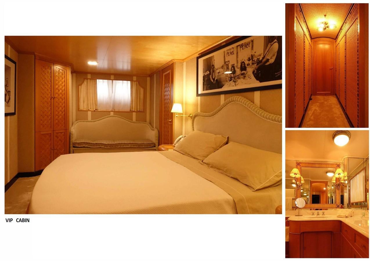 a bedroom with a bed and a mirror aboard SPYK Yacht for Sale