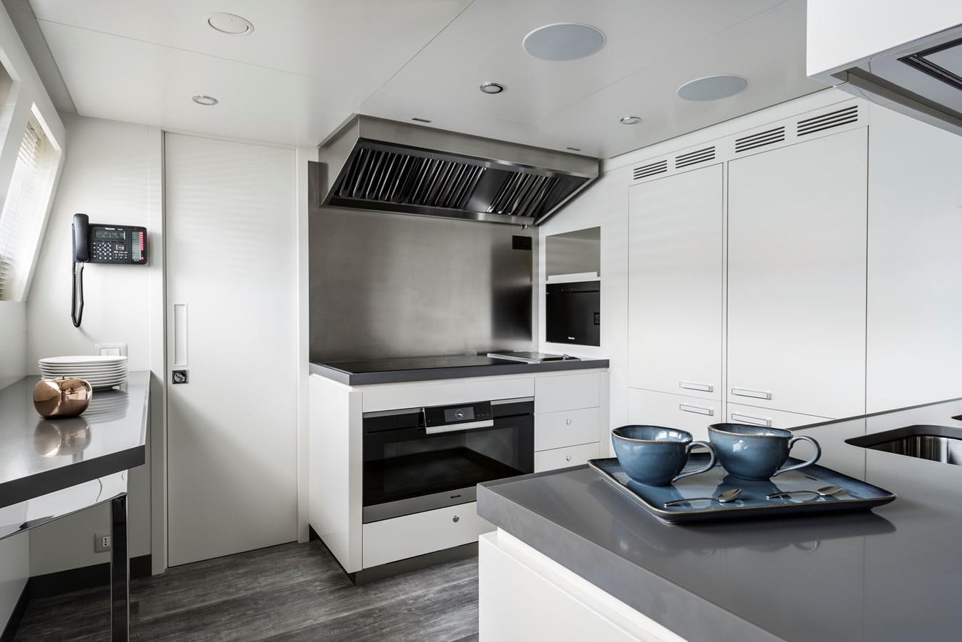 a kitchen with a stove and a microwave aboard CHORUSLINE Yacht for Sale
