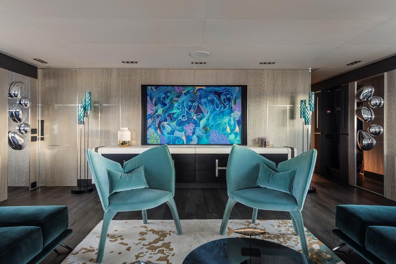 a room with a couch and a tv on the wall aboard CHORUSLINE Yacht for Sale