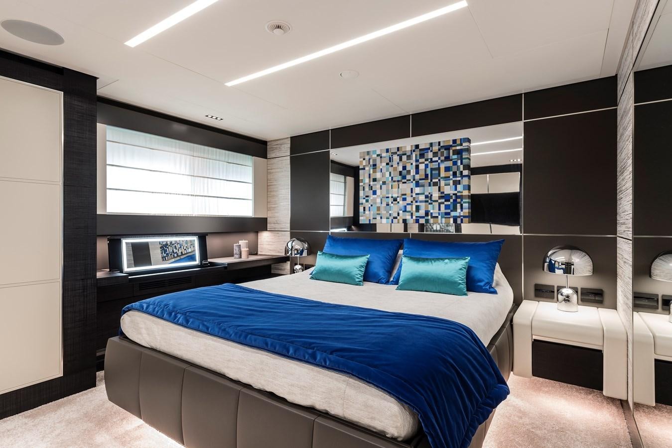a bedroom with a bed and a tv aboard CHORUSLINE Yacht for Sale