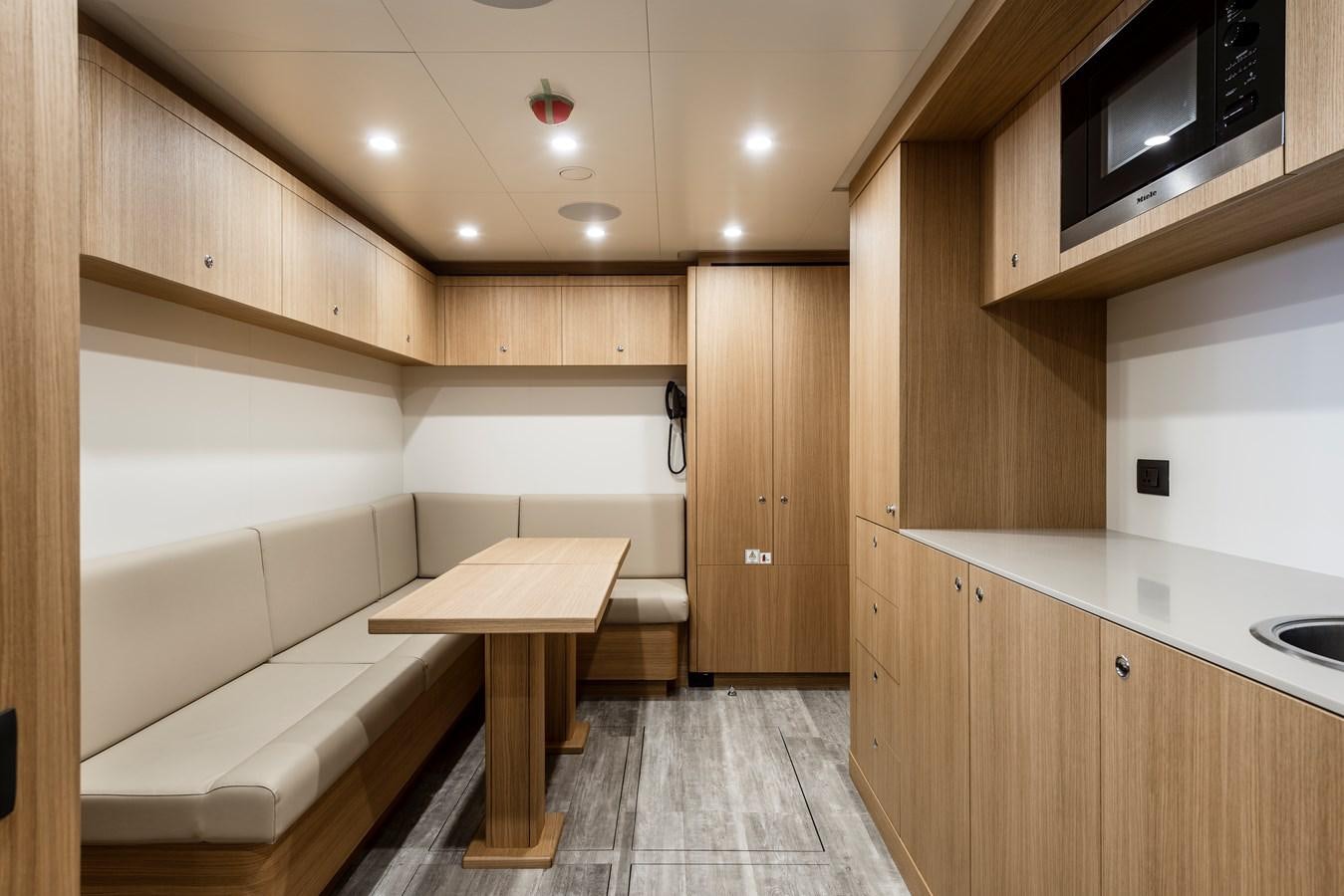 a room with a table and a microwave aboard CHORUSLINE Yacht for Sale