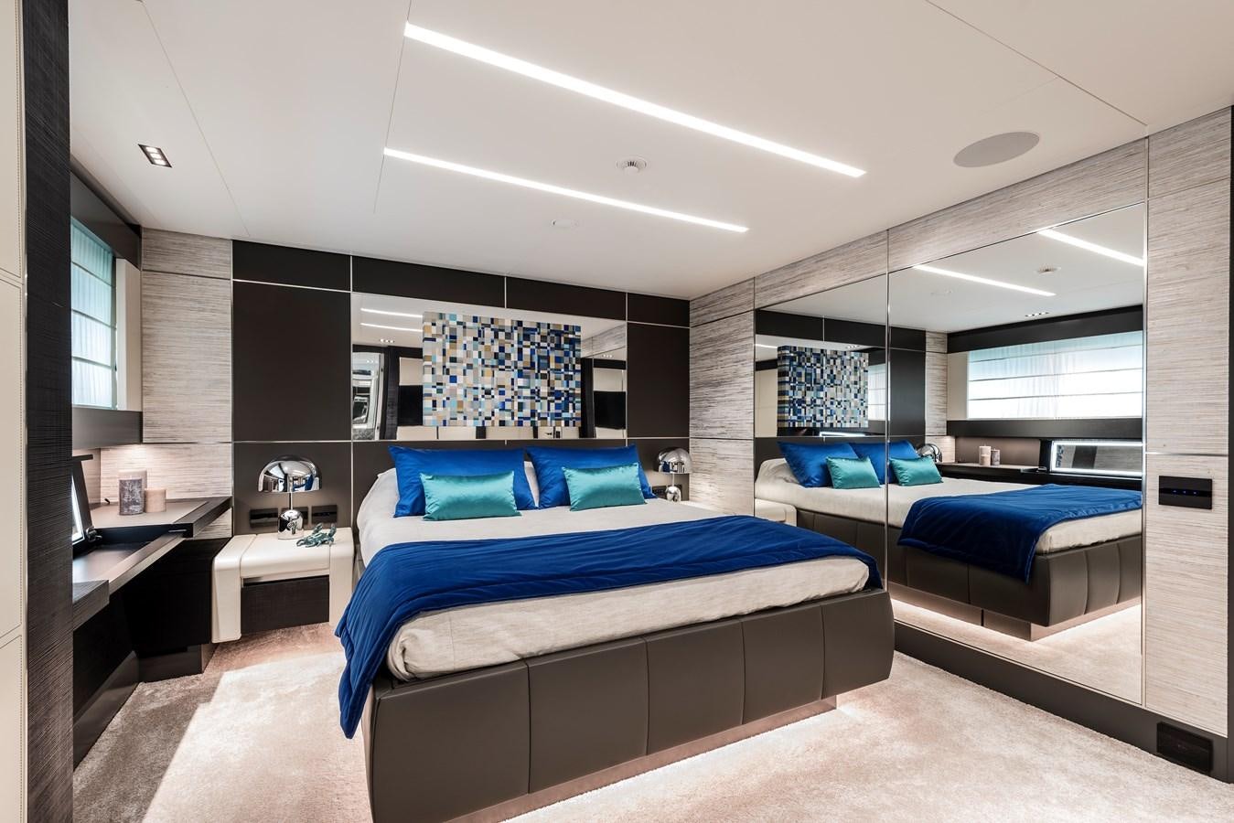 a room with a bed and a desk aboard CHORUSLINE Yacht for Sale