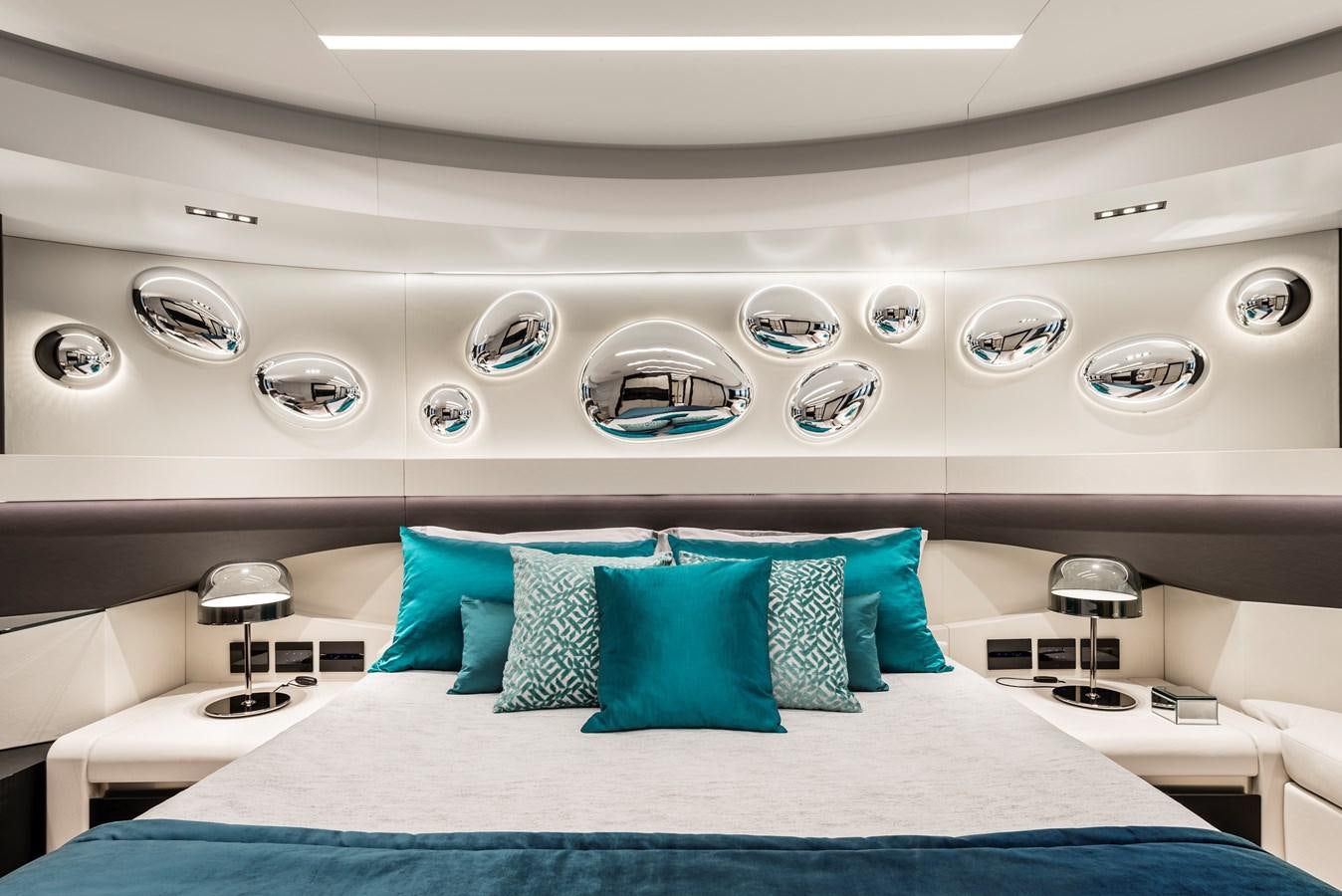 a room with a bed and a mirror aboard CHORUSLINE Yacht for Sale