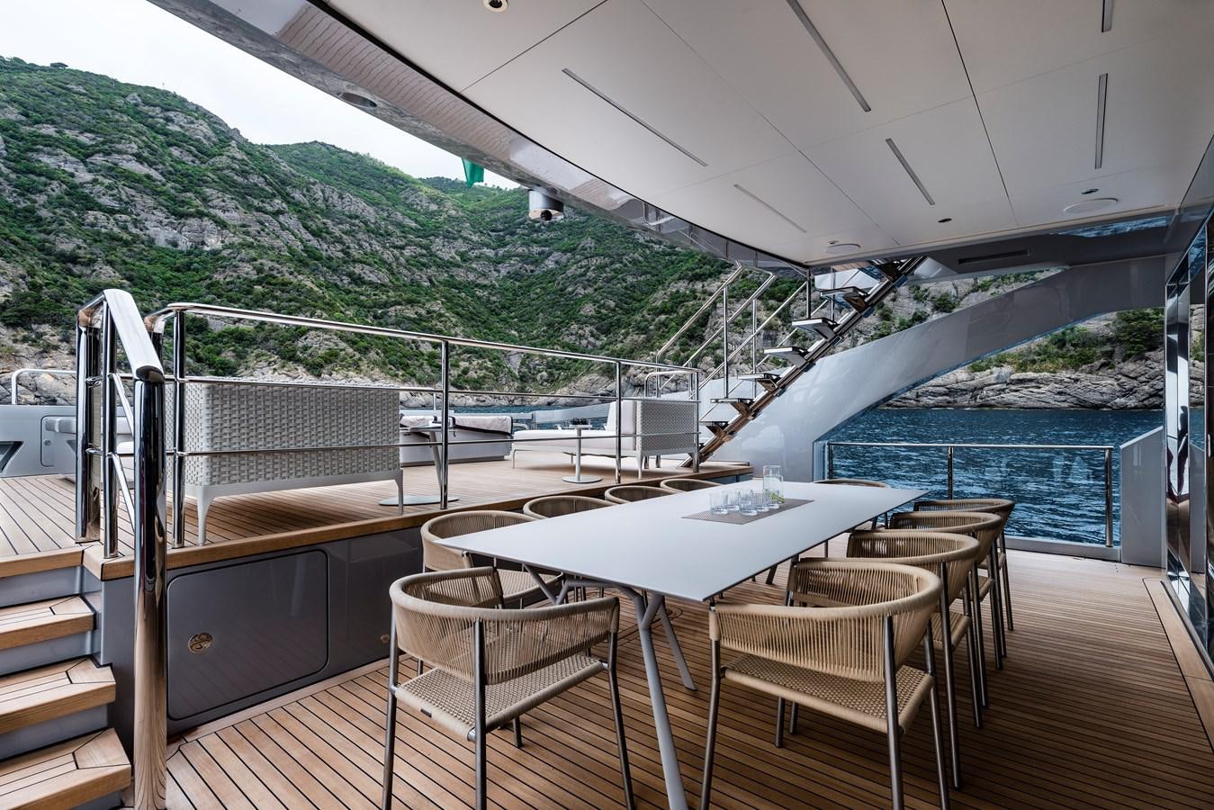 a deck with a table and chairs aboard CHORUSLINE Yacht for Sale