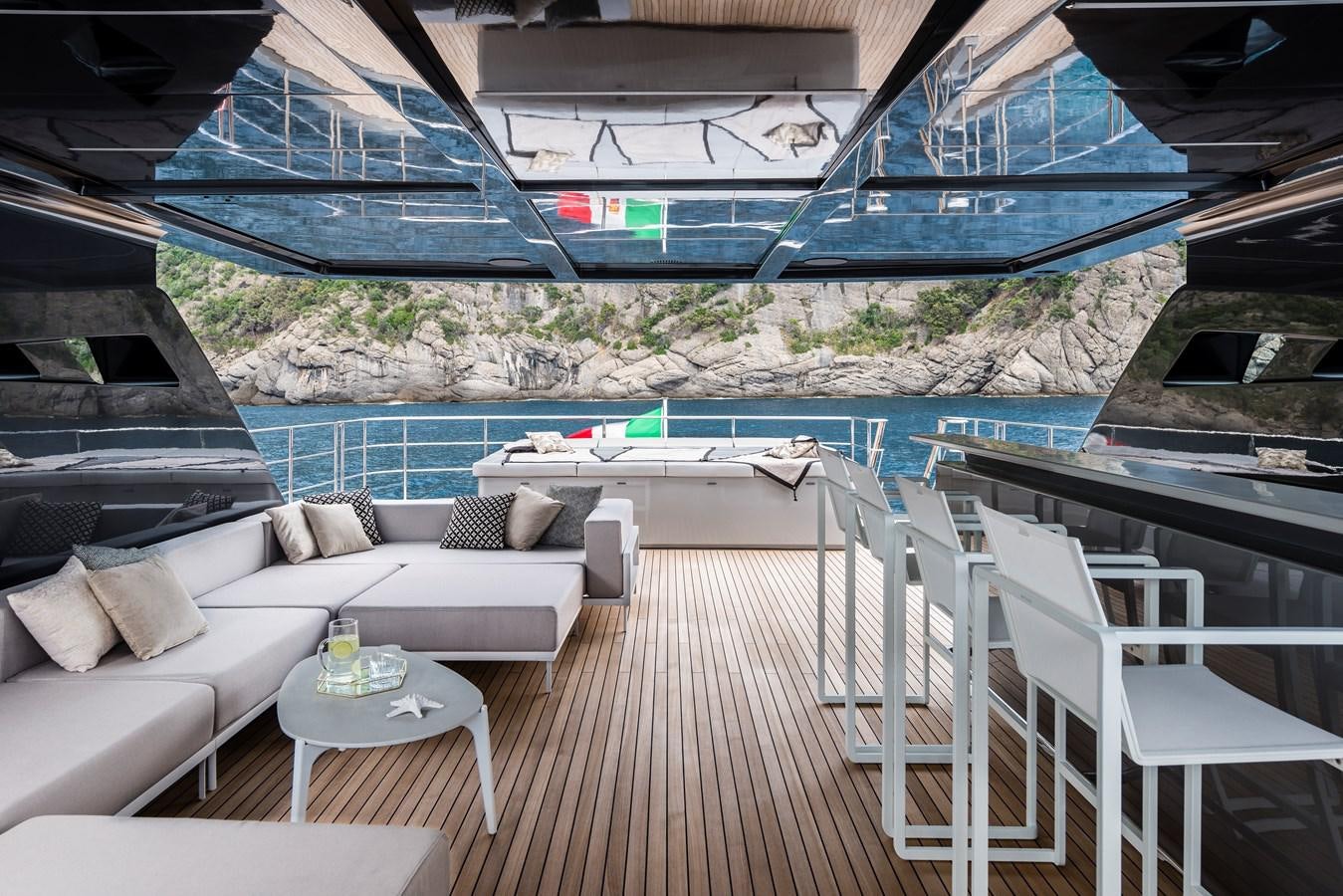 a deck with a pool and a couch aboard CHORUSLINE Yacht for Sale