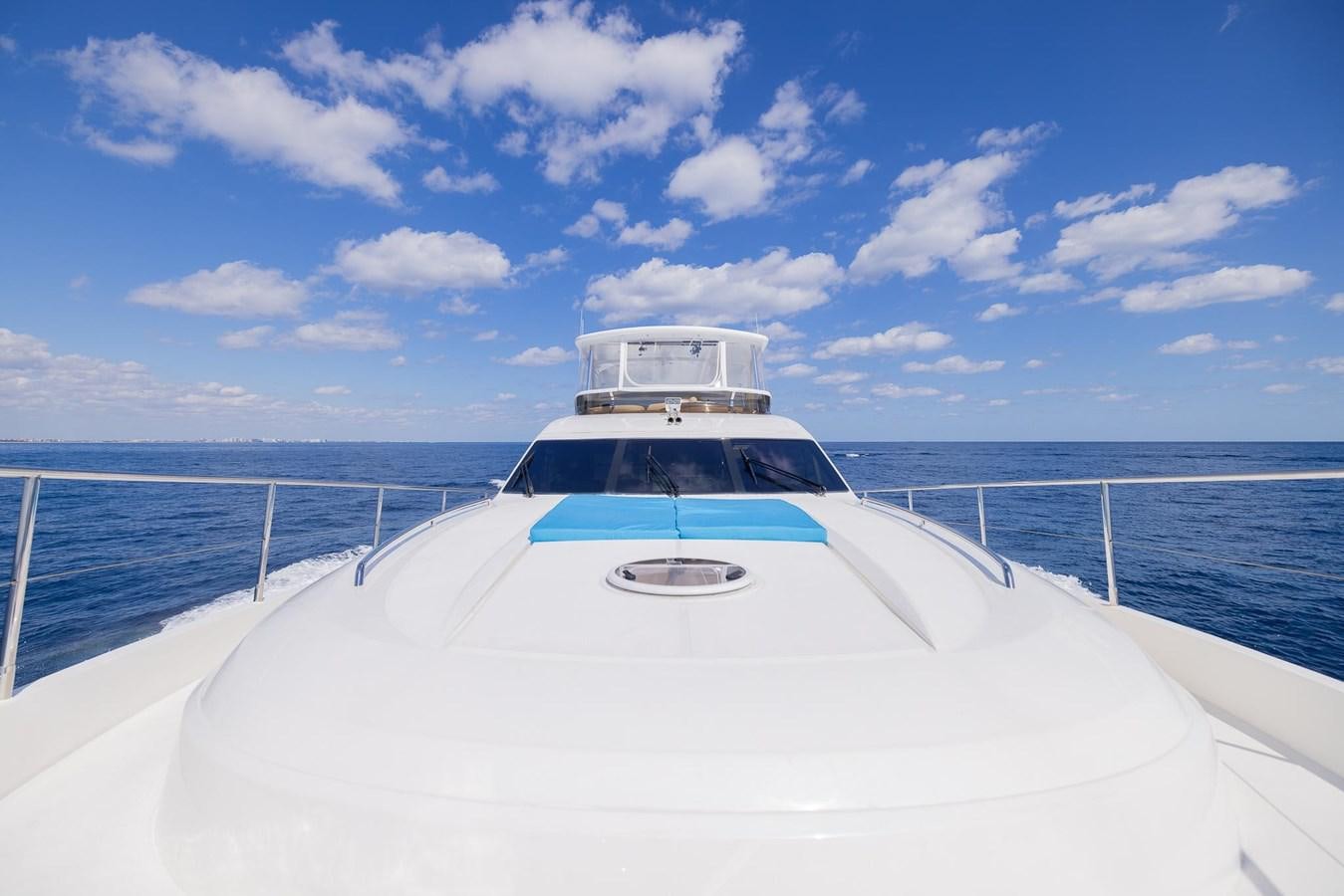 a white boat on a body of water aboard COOL BREEZE Yacht for Sale