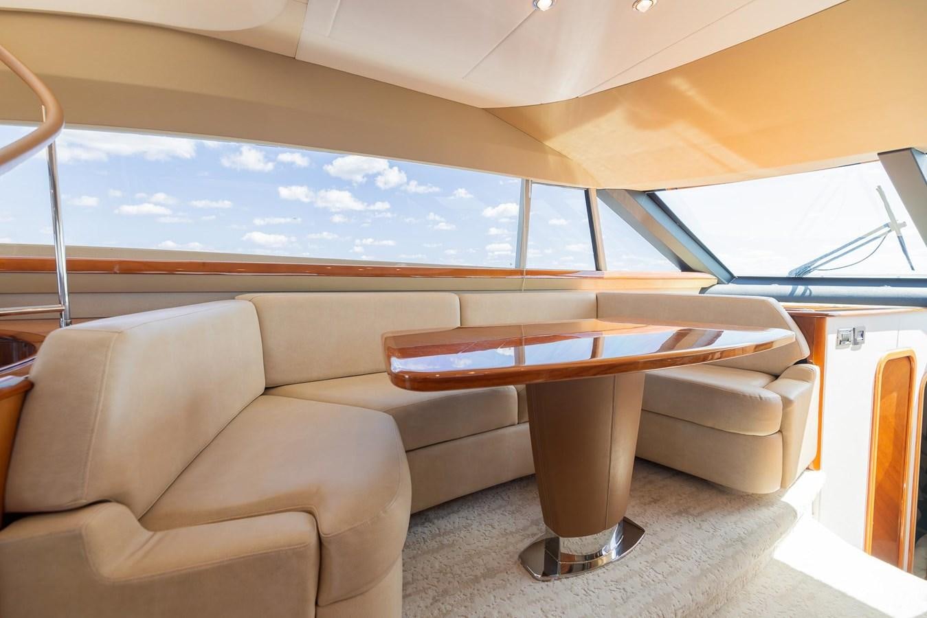a couch and a table in a room aboard COOL BREEZE Yacht for Sale