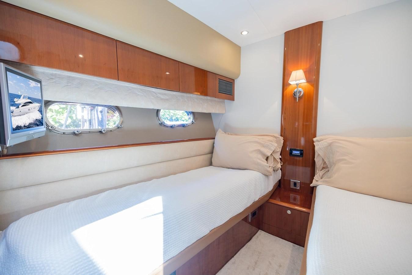 a room with a bed and a television aboard COOL BREEZE Yacht for Sale