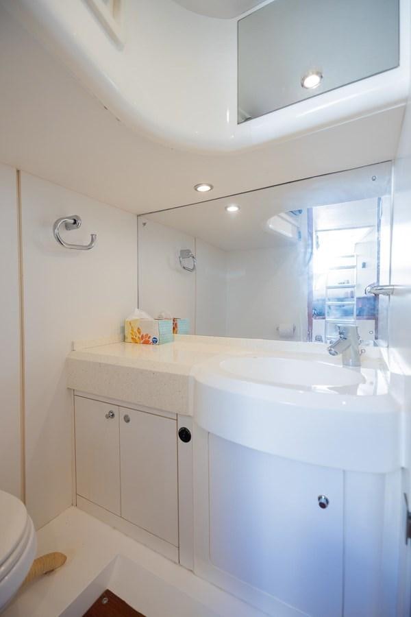 a bathroom with a sink and a mirror aboard COOL BREEZE Yacht for Sale
