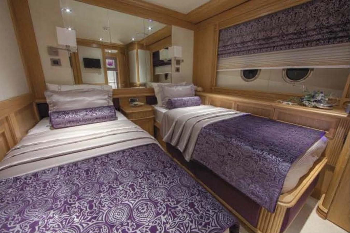 a couple of beds in a room aboard UNDAUNTED Yacht for Sale