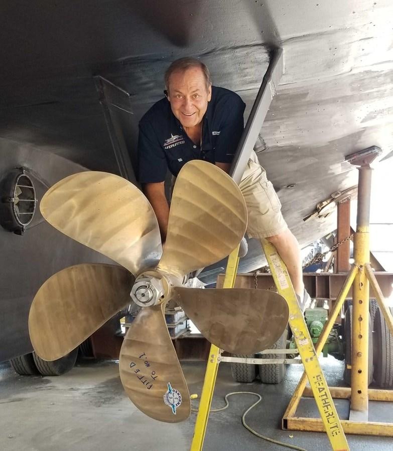 a man working on a machine aboard UNDAUNTED Yacht for Sale