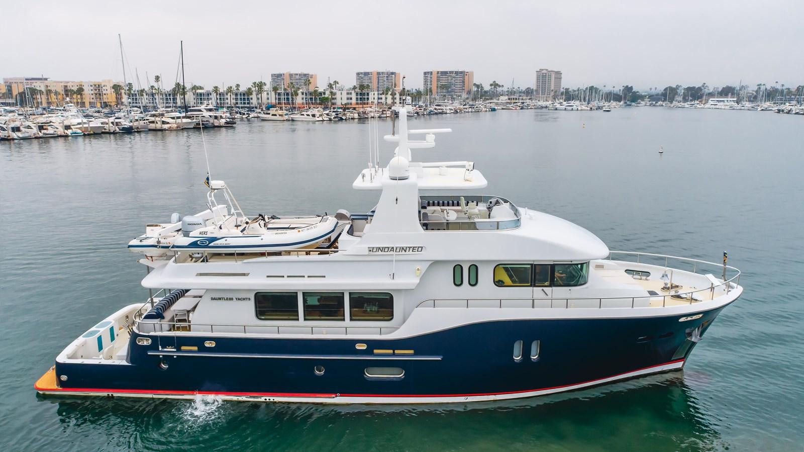 a couple of boats in a harbor aboard UNDAUNTED Yacht for Sale