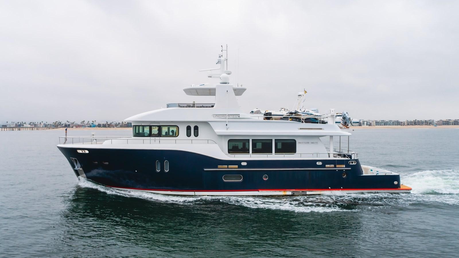 a large boat on the water aboard UNDAUNTED Yacht for Sale