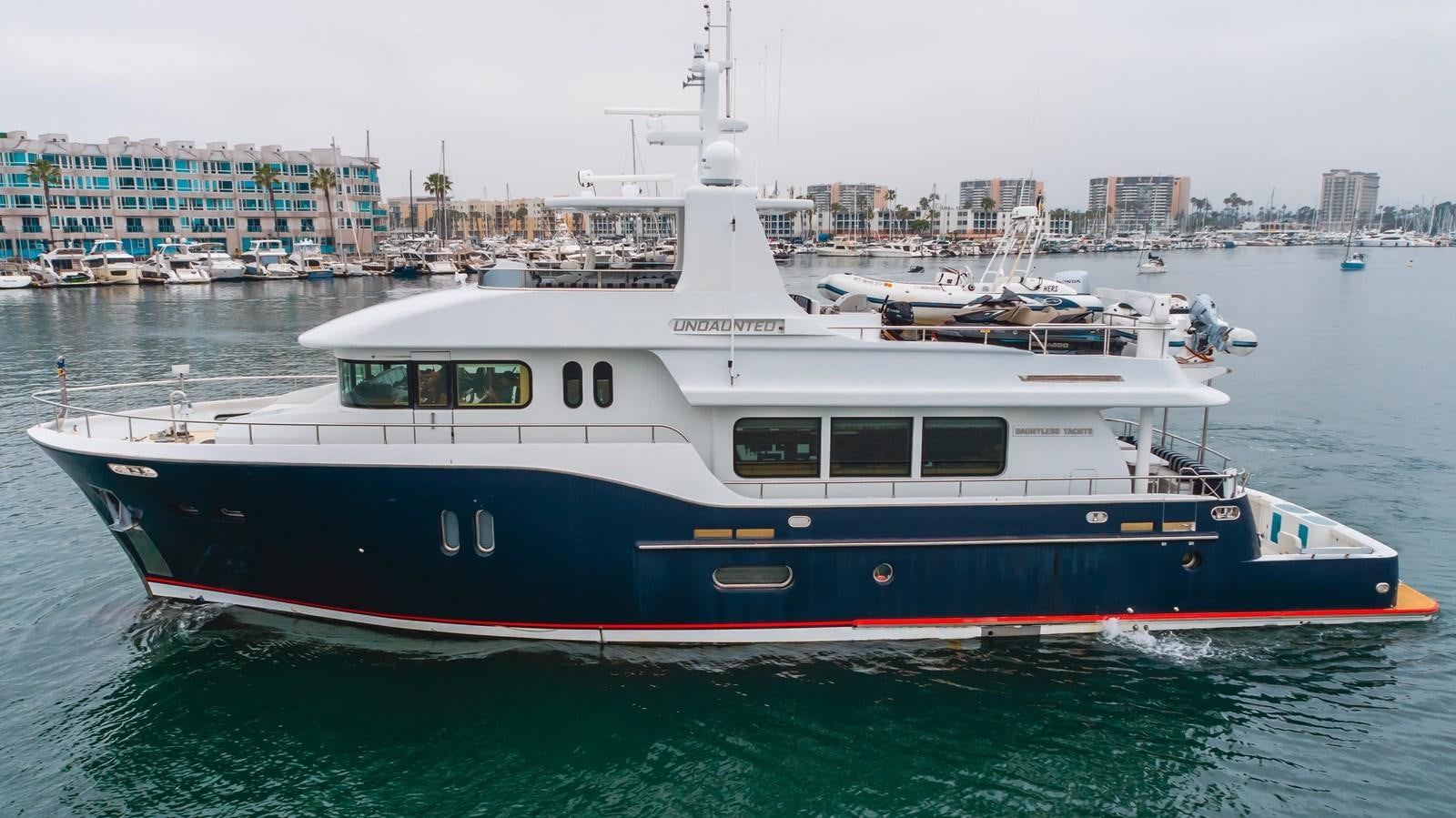 a large boat in the water aboard UNDAUNTED Yacht for Sale