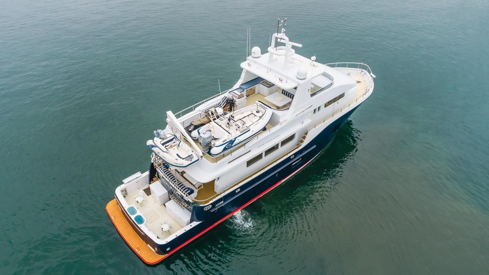 a large boat in the water aboard UNDAUNTED Yacht for Sale