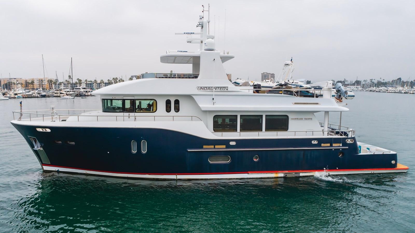 a large boat in the water aboard UNDAUNTED Yacht for Sale