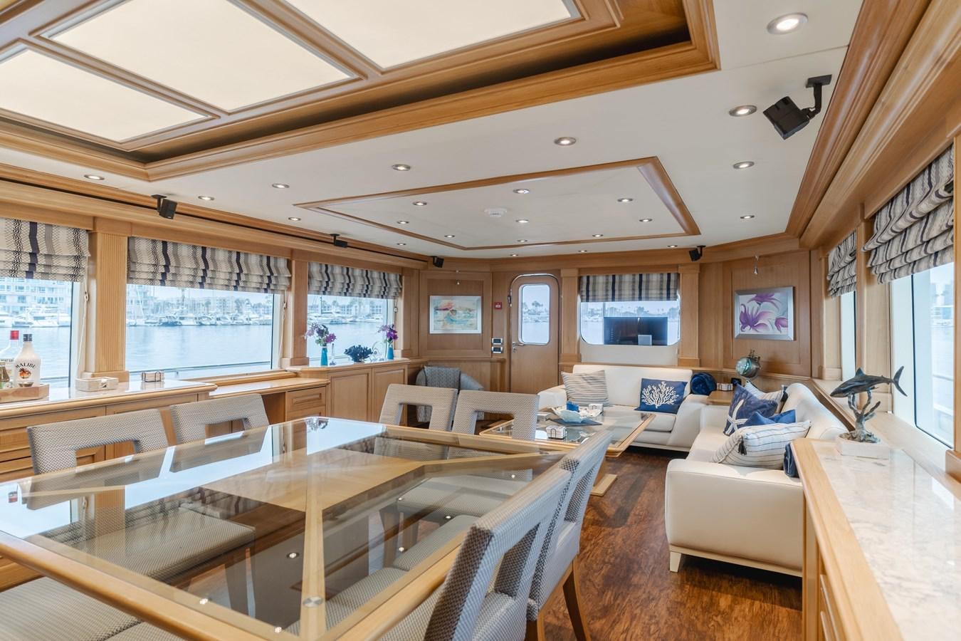 a large living room with a large table and chairs aboard UNDAUNTED Yacht for Sale