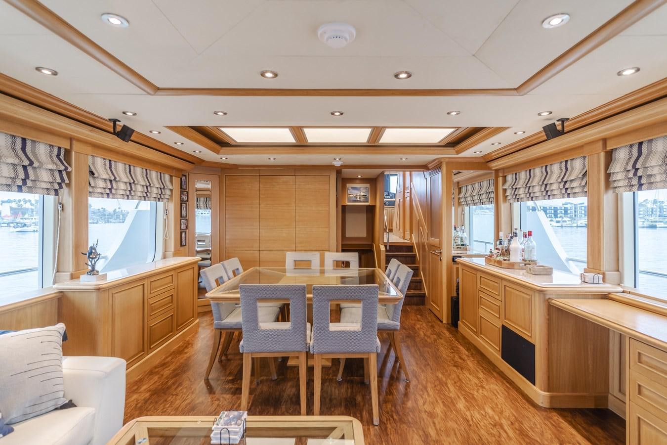 a room with tables and chairs aboard UNDAUNTED Yacht for Sale