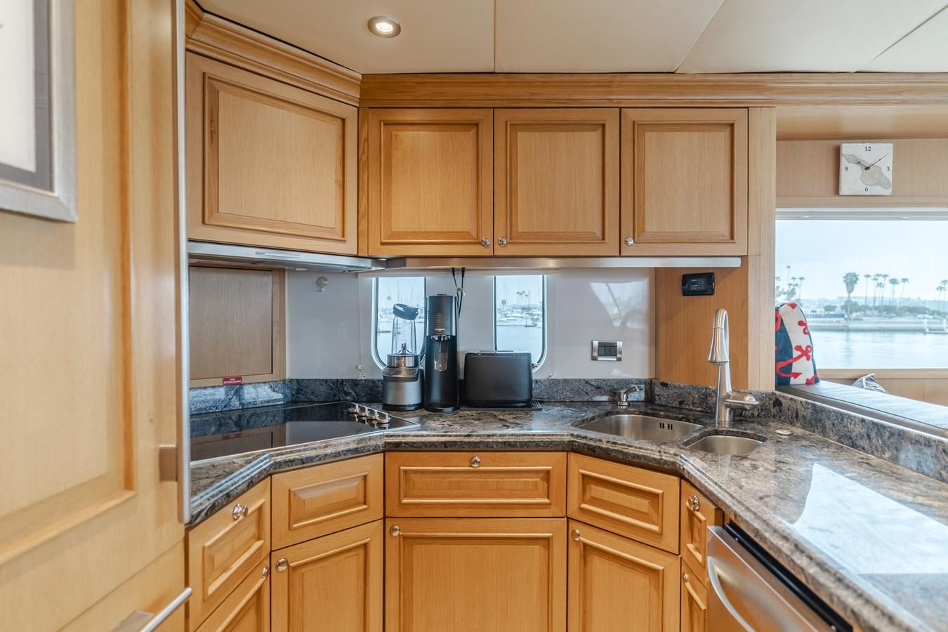a kitchen with wooden cabinets aboard UNDAUNTED Yacht for Sale