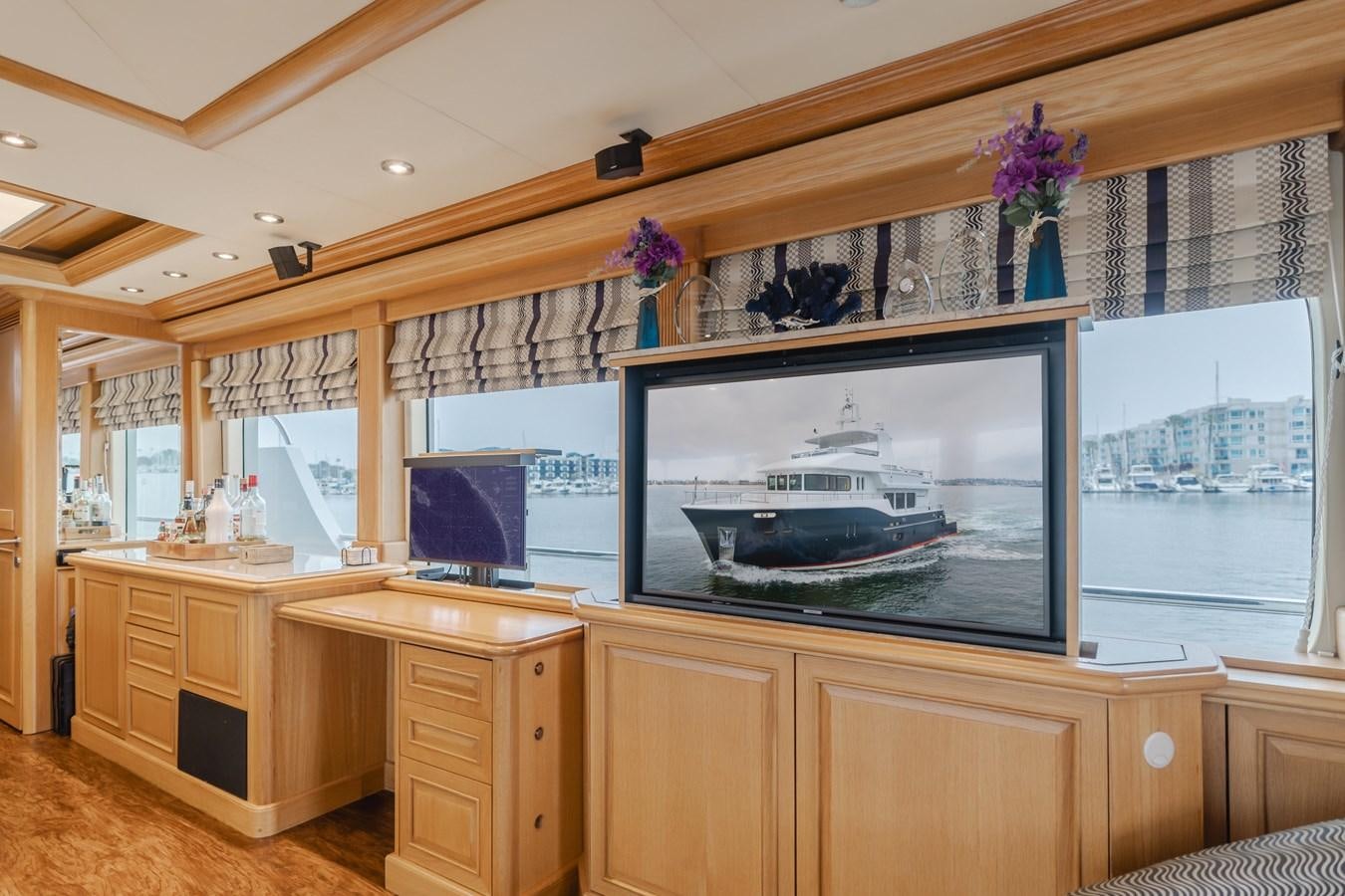 a room with a television and cabinets aboard UNDAUNTED Yacht for Sale