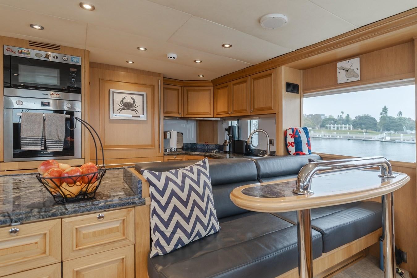 a kitchen with wooden cabinets aboard UNDAUNTED Yacht for Sale