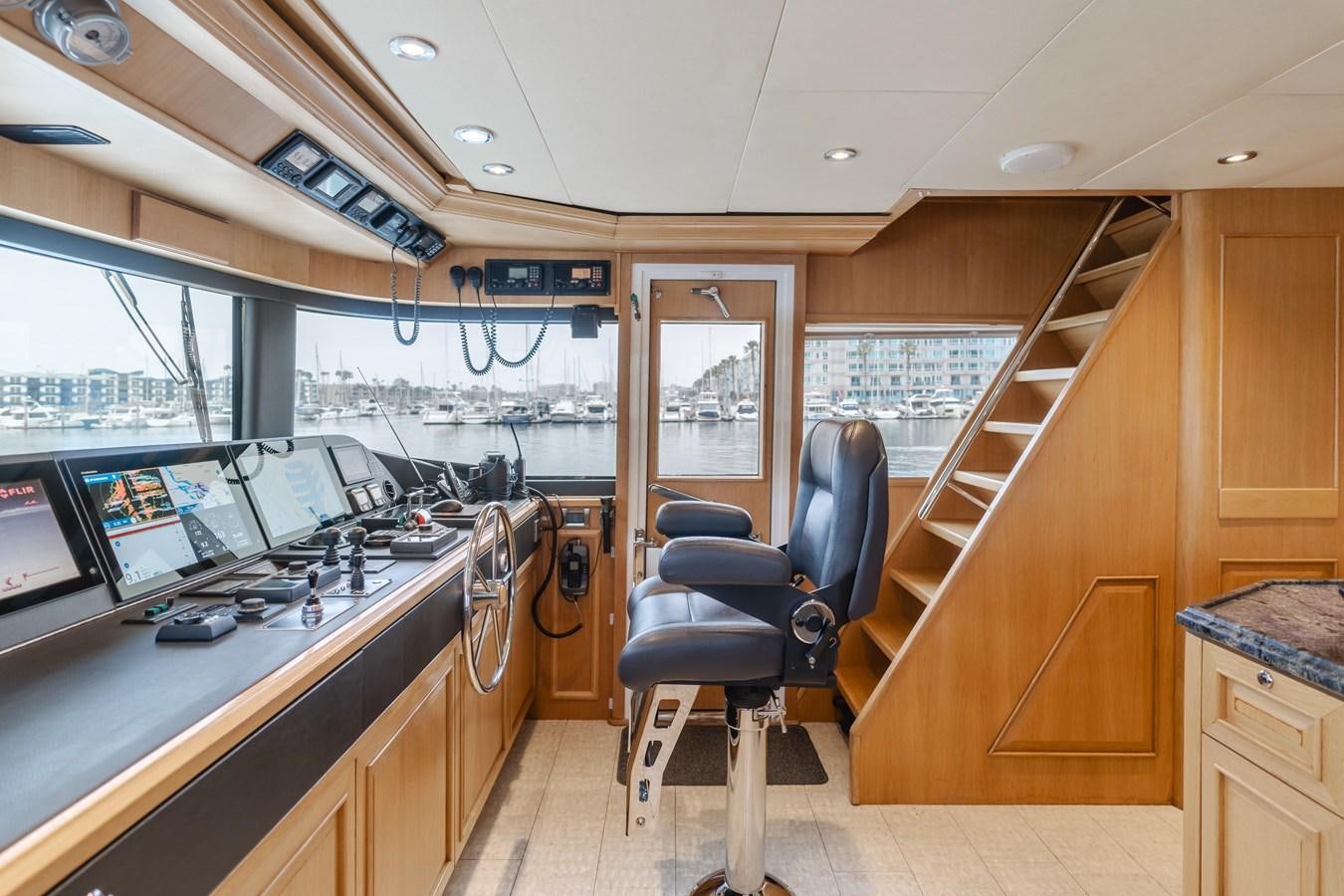 a room with a desk and chairs aboard UNDAUNTED Yacht for Sale