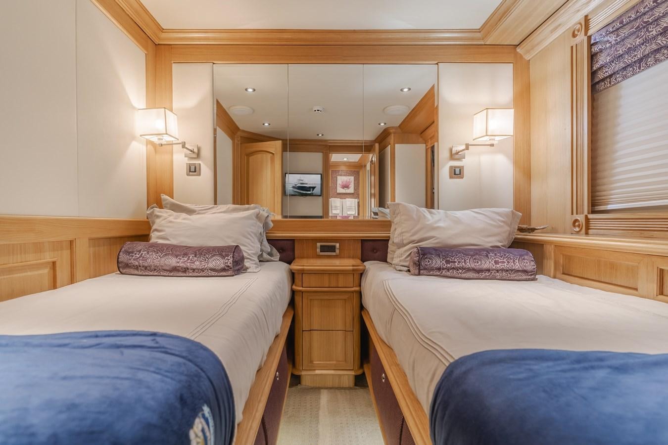 a room with a couple of beds aboard UNDAUNTED Yacht for Sale
