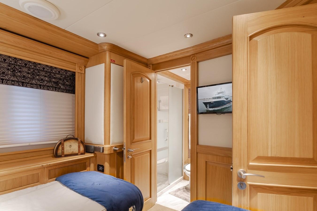 a room with a bed and a closet aboard UNDAUNTED Yacht for Sale