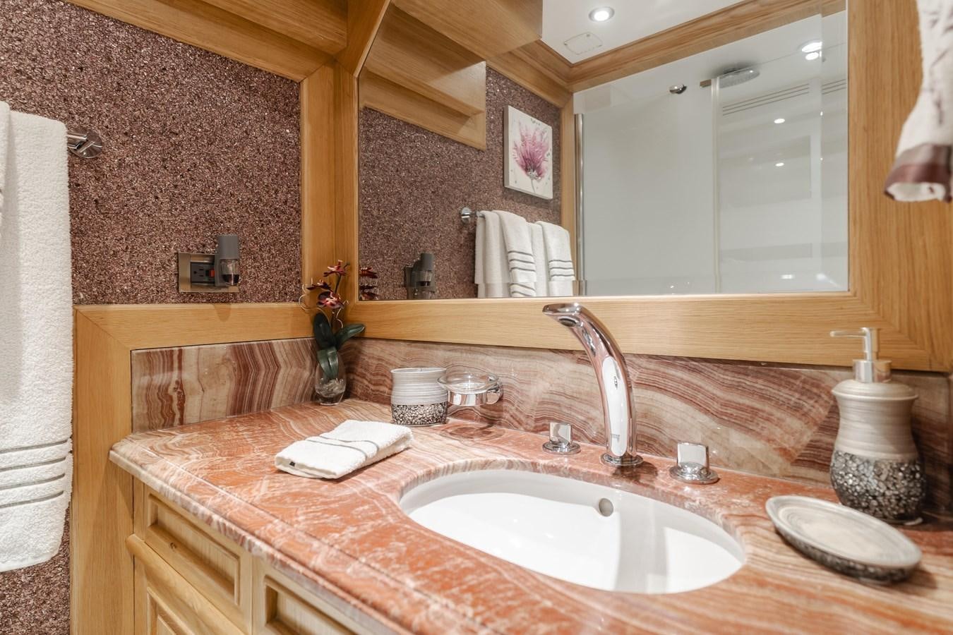 a bathroom with a large mirror aboard UNDAUNTED Yacht for Sale