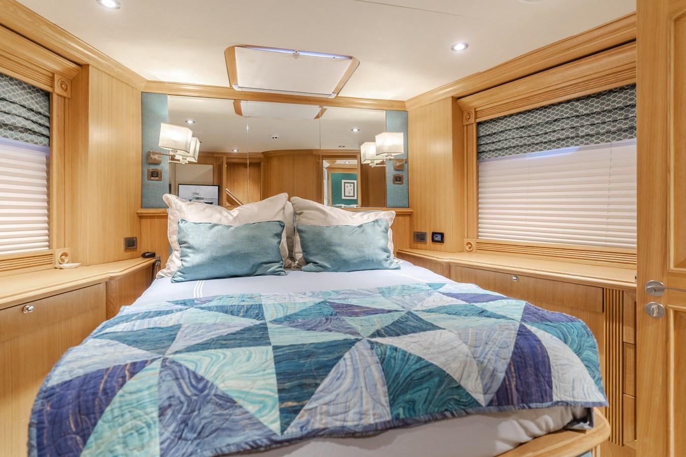 a bed with blue sheets aboard UNDAUNTED Yacht for Sale