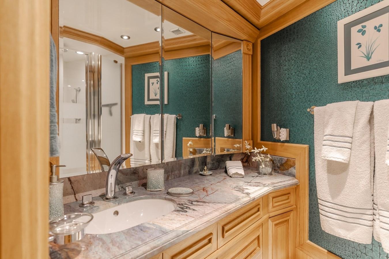 a bathroom with a large mirror aboard UNDAUNTED Yacht for Sale