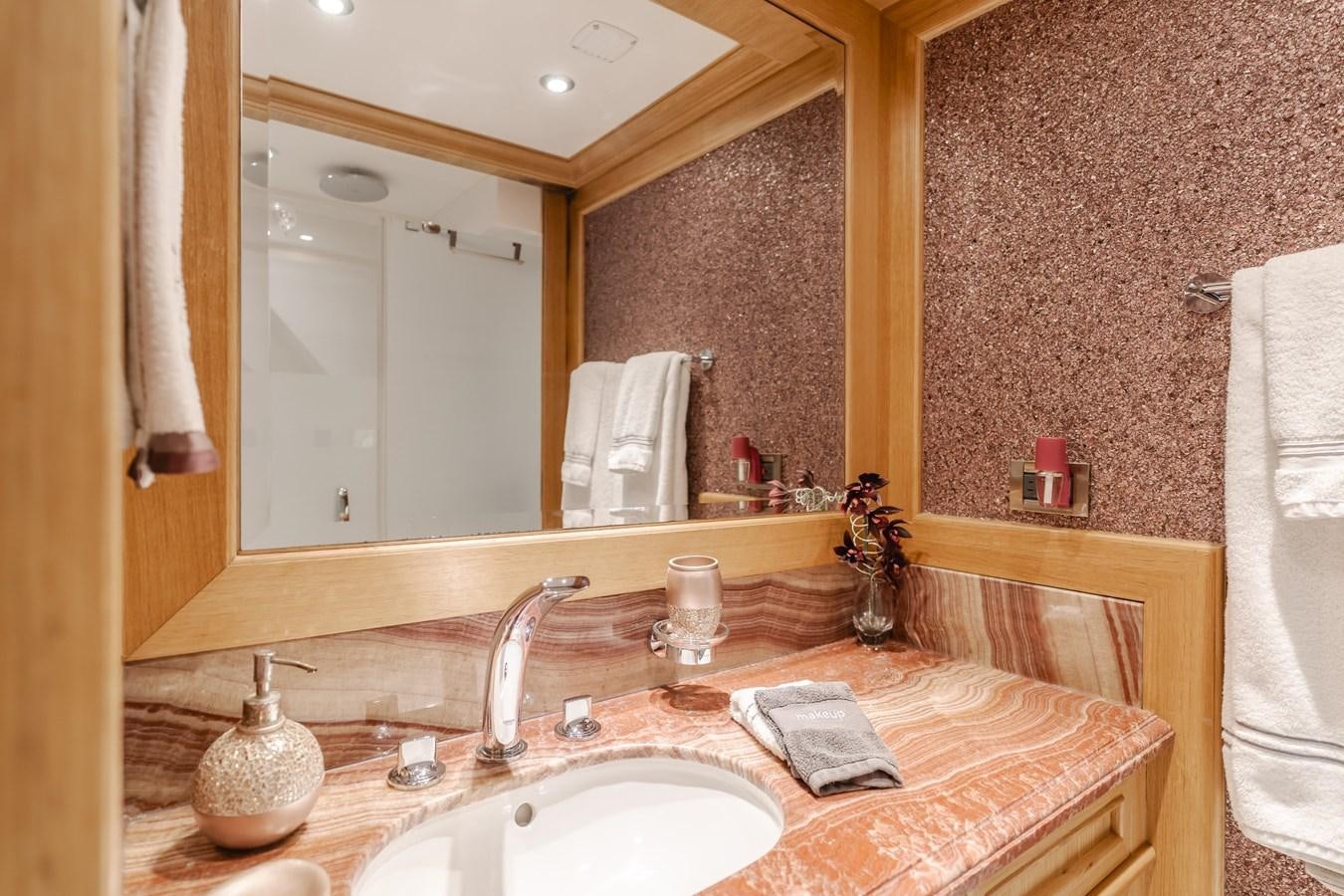 a bathroom with a large mirror aboard UNDAUNTED Yacht for Sale