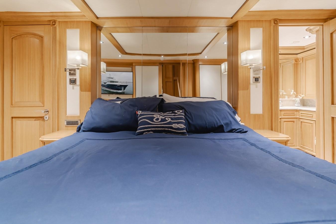 a bed with blue sheets aboard UNDAUNTED Yacht for Sale