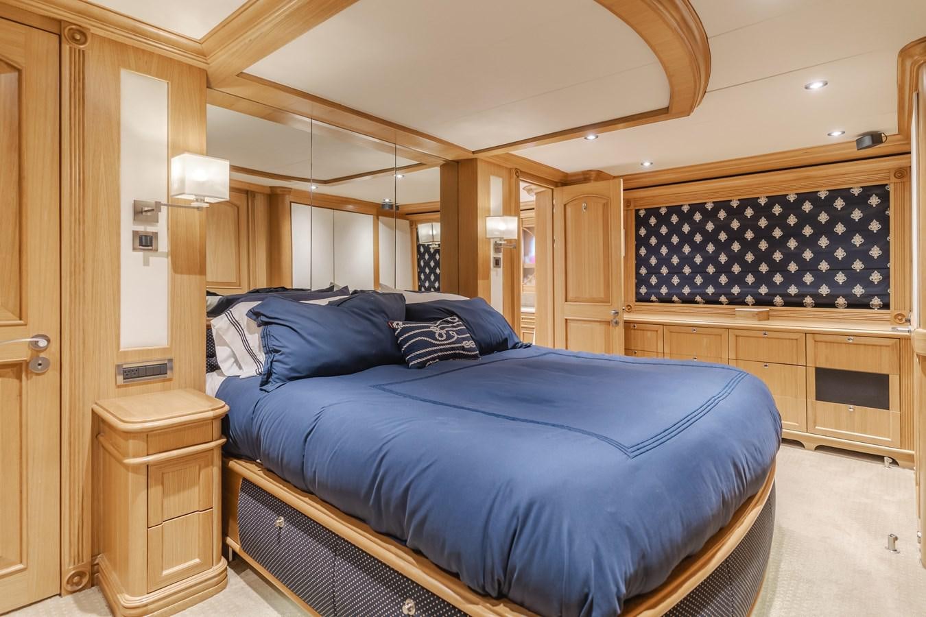a bedroom with a bed and a desk aboard UNDAUNTED Yacht for Sale