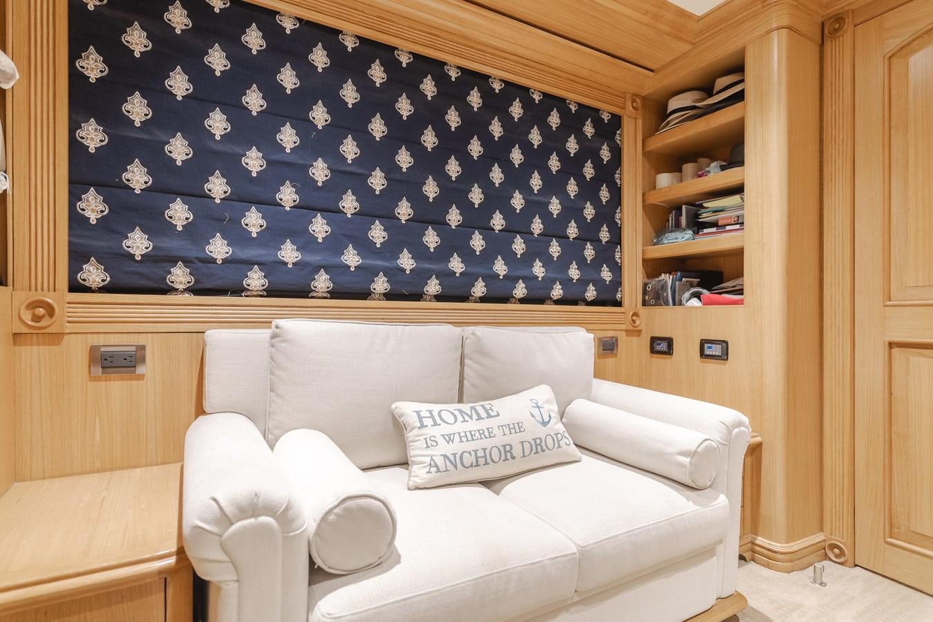 a bed with a blue and white blanket on it aboard UNDAUNTED Yacht for Sale