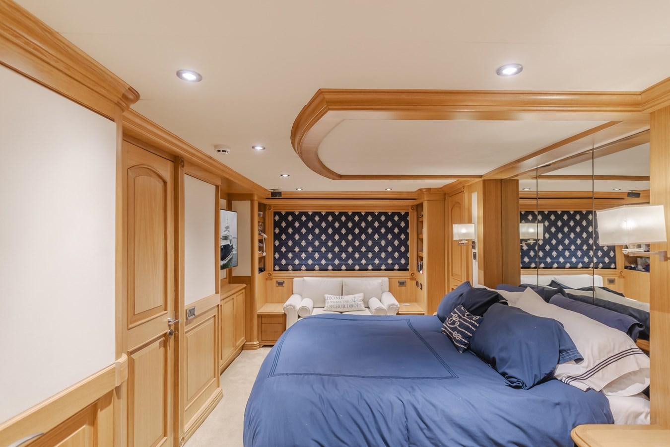 a bedroom with a large bed aboard UNDAUNTED Yacht for Sale