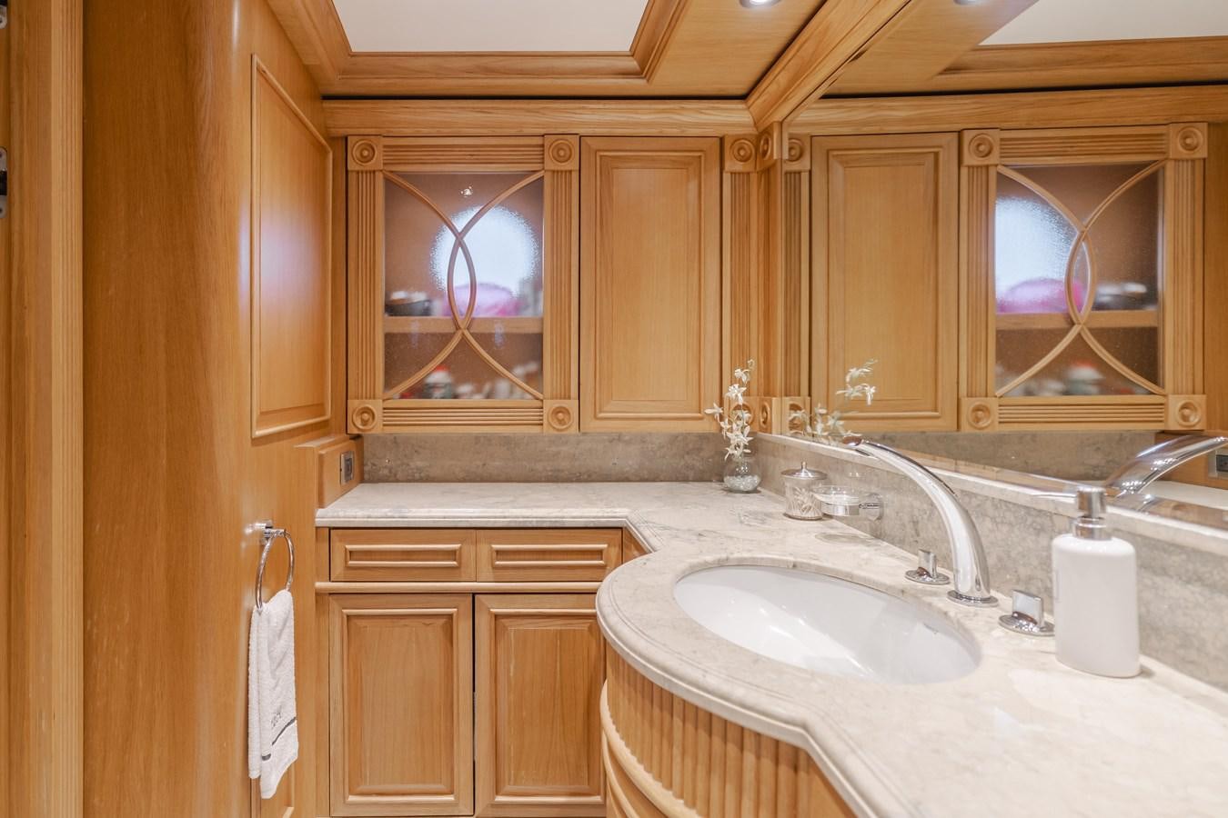 a bathroom with wooden cabinets aboard UNDAUNTED Yacht for Sale