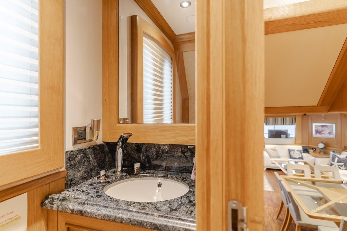a bathroom with a sink and a mirror aboard UNDAUNTED Yacht for Sale